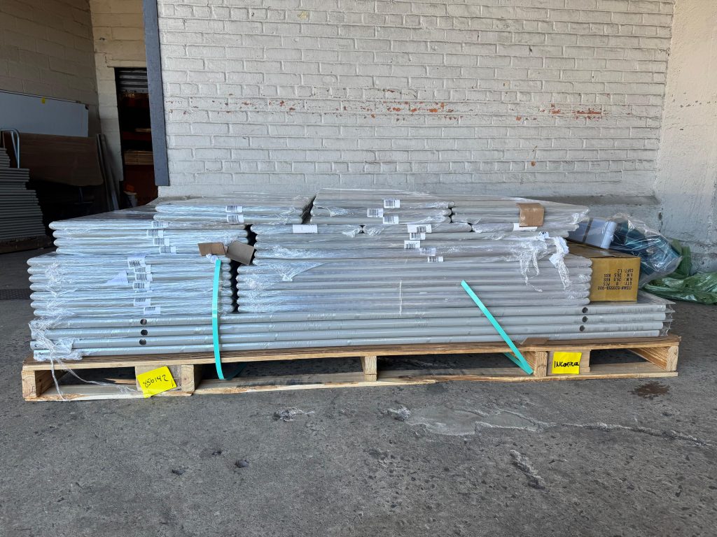 Pallet of wrapped toilet partition panels and pilasters at the Mavi New York Long Island City warehouse loading dock